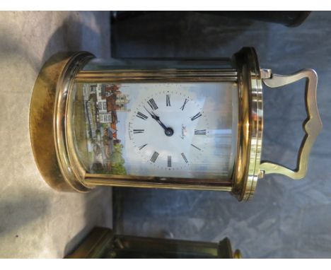 A cylindrical brass carriage clock, the enamel dial depicting Henley-on-Thames, single train movement 16cm high