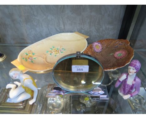 An Art Deco chrome circular picture frame 13cm high, two relief moulded floral design dishes and two 1920s ceramics 'dolls'
