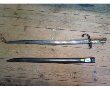 A 19th century French bayonet, with brass handle and a metal scabbard, the blade engraved Mre Nle Chat Aout 1871, length of b