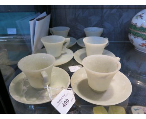 A set of six jade coffee cups and saucers, saucers 11cm diameter