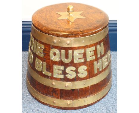 A brass-bound oak rum barrel of tapering form, with star finial plate and brass letters to the body 'THE QUEEN GOD BLESS HER,