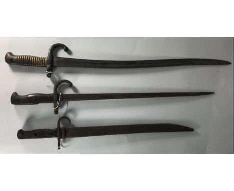 Two various French 'Chassepot' bayonets, comprising 1878 pattern 19.5" blade and wooden grips, the second with 22.5" Yataghan