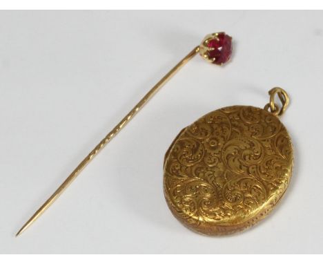 Unmarked yellow metal oval locket, (appears 15ct or higher), together with an unmarked yellow metal stock pin claw-set with a