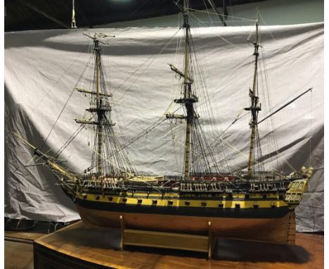 A large model ship of HMS Agamemnon, fully rigged, 64 gun, copper hull, on wooden display stand, approx. 110cm wide, together