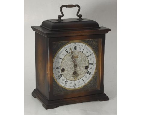 An early 20th century oak cased mantel clock by Kienzle, white and gilt dial with Roman numerals and gilt spandrels to each c