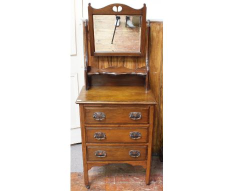 An Edwardian walnut dressing table with later added mahogany tilt-top mirror, three drawers with Art Nouveau copper handles, 