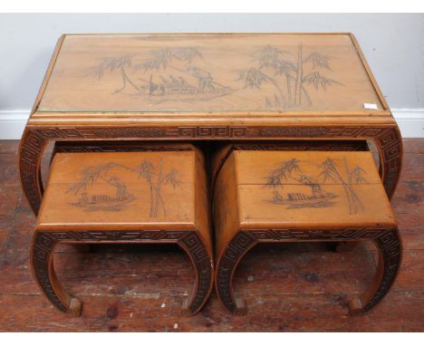 An Oriental coffee table nest with four smaller tables/stools, engraved with a scene of characters fishing off a small boat a