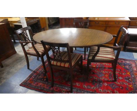 An Oval Mahogany Dining Table and Four Regency Striped Dining Chairs (In Need of Reupholstery) 