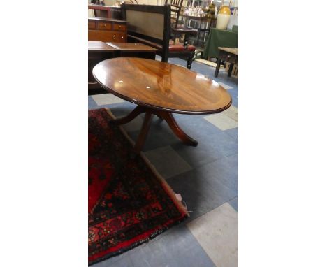 A Mahogany Oval Coffee Table on Quadrant Support with Claw Feet, 121cm Wide 