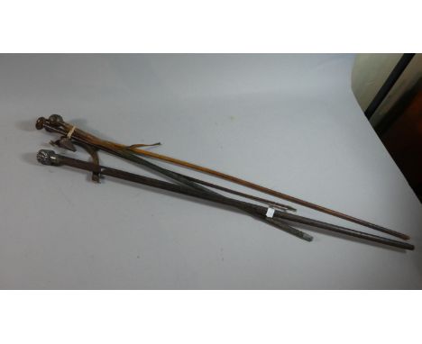 A Vintage Swagger Stick, Silver Mounted Cane (AF), Silver Mounted Riding Whip and a Leather Riding Whip 