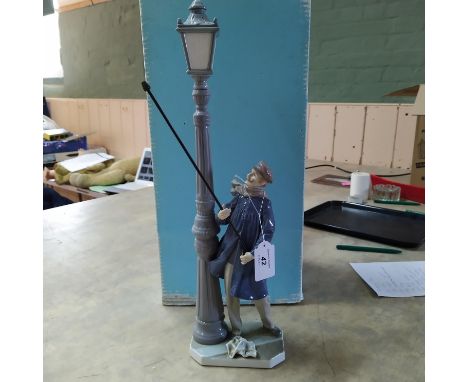 A boxed Lladro figurine The Lamp Lighter, signed to base by a member of the Lladro family, 18 1/2" high (missing a thumb and 