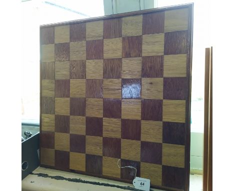 A wooden chess board with ornate resin chess set of Vikings