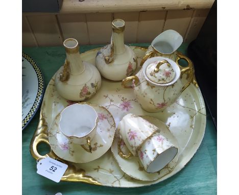 A late 19th Century porcelain part cabaret set comprising a two handled tray, three cups and saucers, sucrier and cream jug p