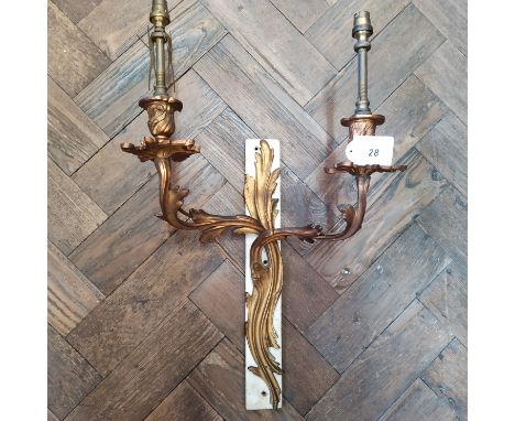 An Edwardian gilded brass two branch wall light