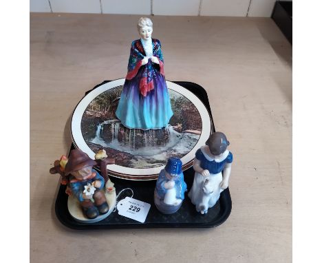 Two Doulton Series ware plates plus a Paragon Grand Ma Ma figurine, a Hummel seated boy and two Danish figures, one Royal Cop