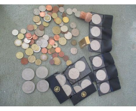A quantity of coins to include Churchill crowns, together with a gold coloured Dunhill lighter 