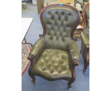 A Victorian spoon back salon armchair having green button and stud leather back upholstery 