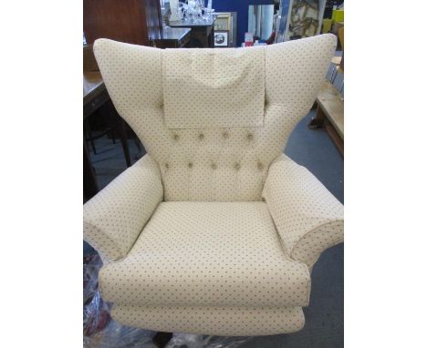 A modern possibly G-Plan swivel wing back armchair in cream upholstery with small light brown square pattern, in very good co
