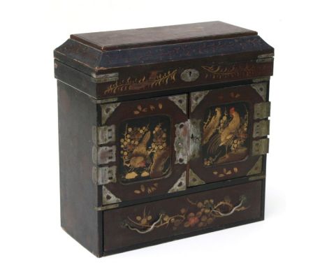 A late 19th century Japanese table top cabinet, the lift-up lid with sectioned interior above a pair of cupboard doors enclos