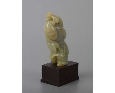 A Chinese jade / hardstone figural group depicting a robed man with a monkey on his back, on a hardwood stand, 9cms high.