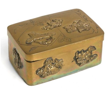 A Japanese rectangular brass snuff box decorated in relief with birds and mythical beasts, 10cms wide.