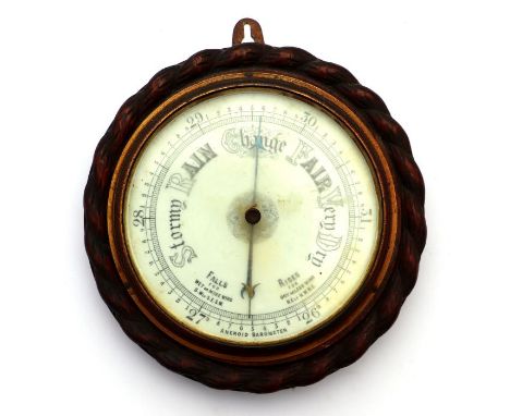 A Victorian wall mounted aneroid barometer with white ceramic dial fitted an oak rope twist case, 27cm wide 