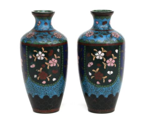 A pair of Japanese cloisonne miniature enamel baluster vases, each decorated with panels of flowers on a blue ground, 13cms h