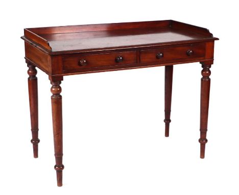 A Victorian mahogany writing table or library table with three-quarter gallery top above two frieze drawers, on ring turned t