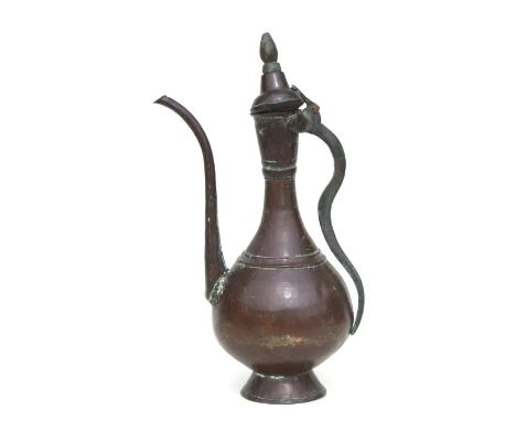 A Turkish / Islamic copper ewer or coffee pot, 50cms high.