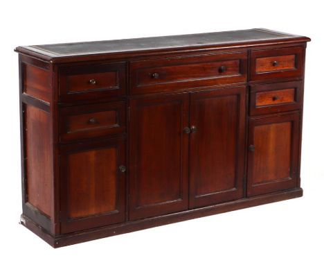 A mahogany side cabinet with an arrangement of five drawers and four cupboards, on a plinth base and a leather inset top, 148