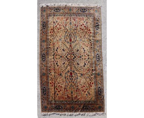 A fine quality Indian hand knotted rug with stylised trees, deer and birds on a light brown ground within floral and bird bor