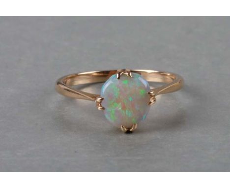 An opal and gold ring, marks rubbed, approx UK size 'P', cased. 