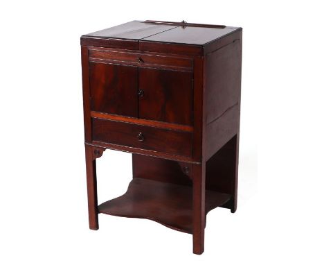 A Georgian mahogany gentleman's washstand, the folding top enclosing a fitted interior with a rise-and-fall mirror, drawers, 