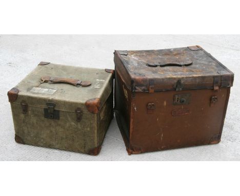 A leather travel trunk, 53cms wide; together with a canvas trunk with leather bound corners, 45cms wide; and military issue t
