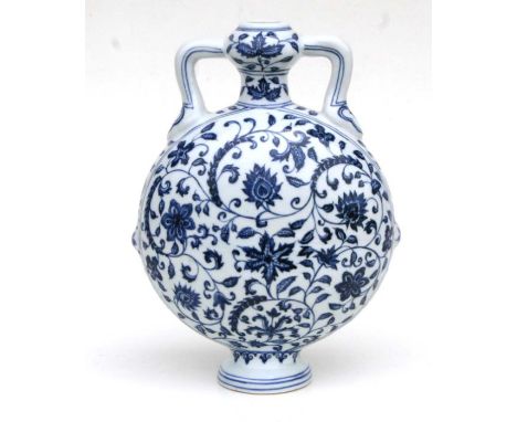 A Chinese blue and white moon flask decorated scrolling flowering foliage, 29cm high 