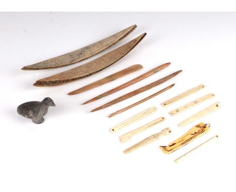 A quantity of Inuit carved bone items &amp; tools; together with a small carved stone bird.