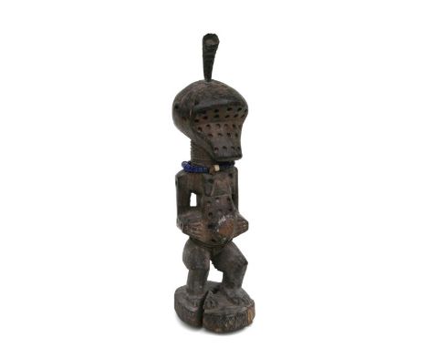 African Art / Tribal Art: A Songye power figure, perforated holes throughout, medicine bundle and horn on head. 35cm high:  P