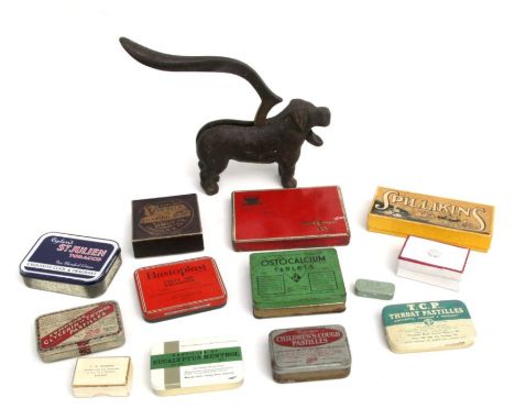 A quantity of vintage tins and boxes to include Vinolia shaving soap and Ostocalcium tablets; together with a cast iron dog f