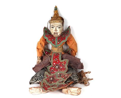 A large Burmese puppet with glass eyes and talking mouth, in traditional costume, approx 64cms high.