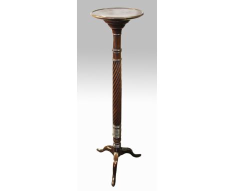 A mahogany torchere stand with turned and twisted column on tripod base.