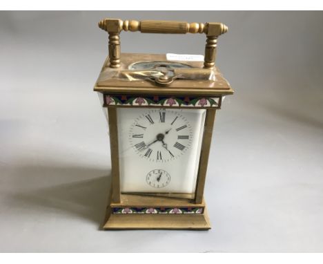 A Carriage clock with enamel decoration.