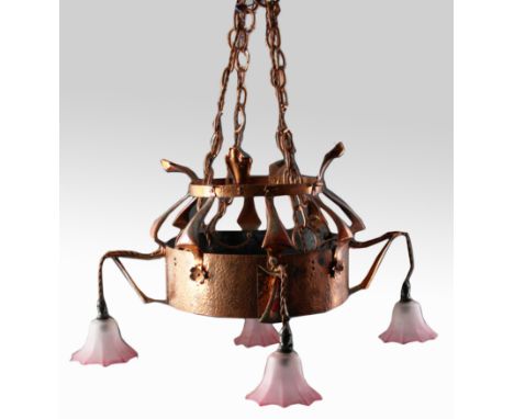 An arts and craft hand beaten copper ceiling light fitting, with four pink glass shades