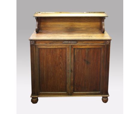 A 19th Century rosewood two door cupboard with shelf back and pierced brass gallery.