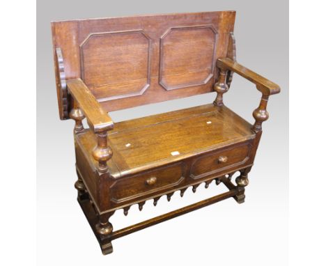 An oak carved topped monks bench with lift up seat.