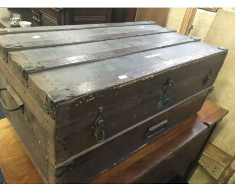 A wood bound travel trunk.
