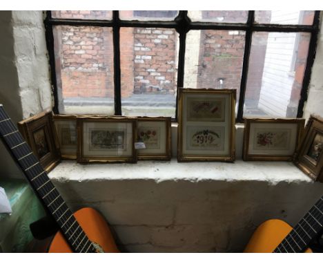 Six framed postcards sent by soldiers during the First World War, together with two framed images of flowers.