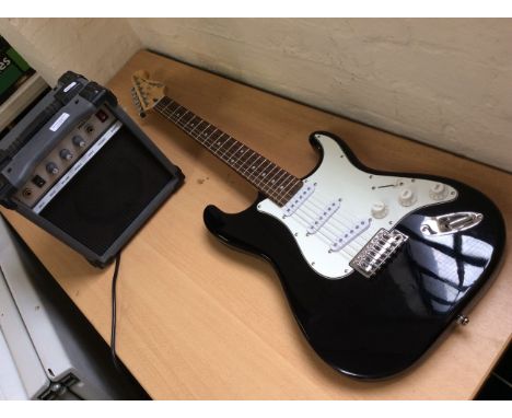 A black Cruiser by Crafter electric guitar with a Sound King SKAK10A amplifier.