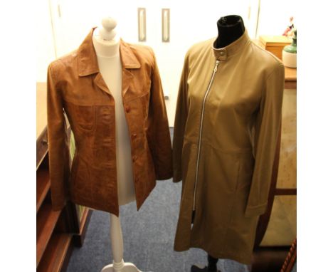 Two ladies leather jackets, one light brown and one tan.