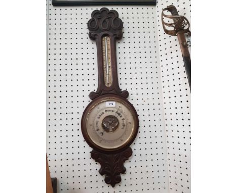 the carved banjo frame enclosing a barometer and thermometer 