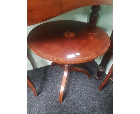 of circular form raised on a single pillar support terminating in a tripod base 
